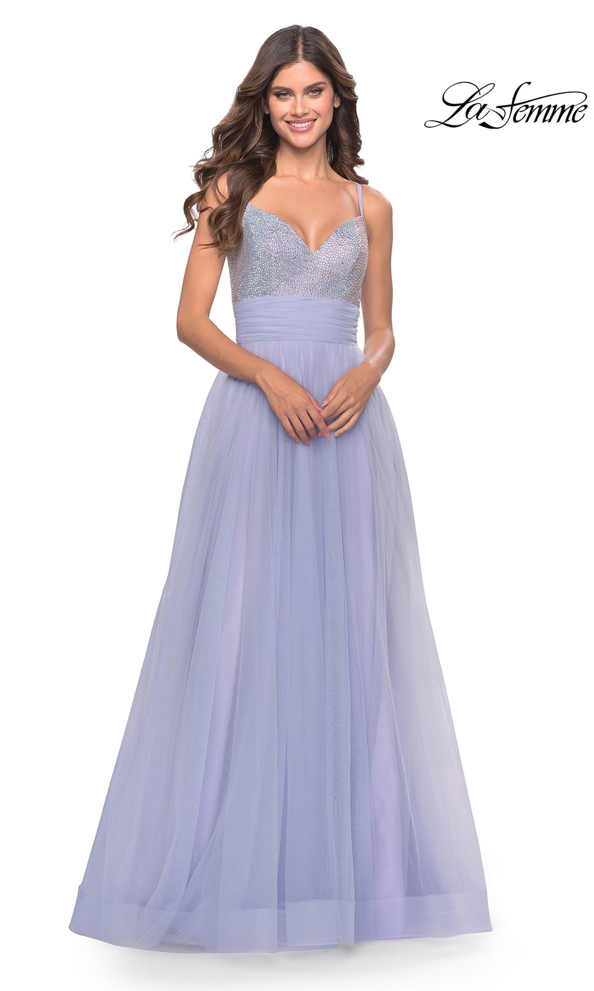 A woman models the La Femme 31433 Beaded-Bodice Long Prom Dress in lavender tulle with an embellished v-neck and thin straps, standing against a white background. The La Femme logo is visible in the top right corner.